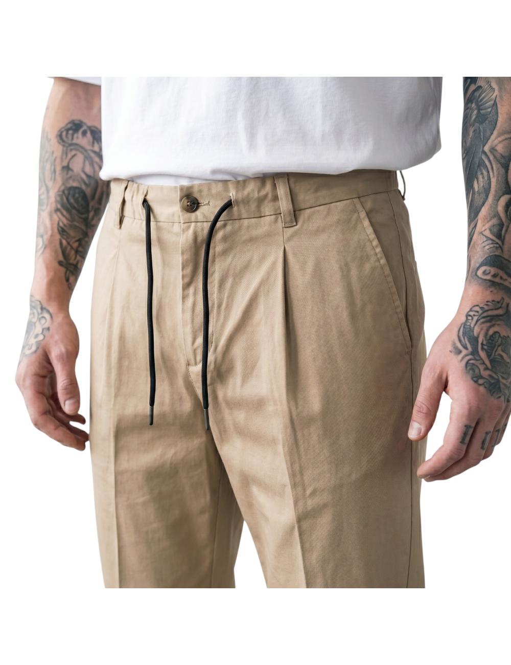 Beige trousers outfit with...