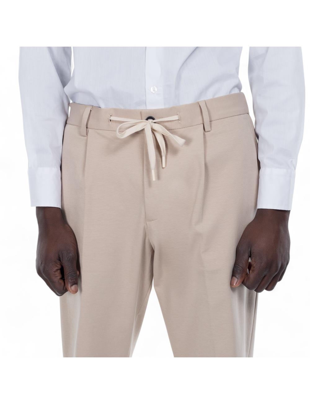 Beige trousers outfit with...